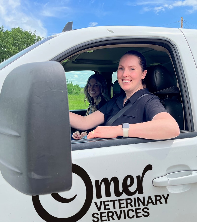 Dr. Maggie Pellerin and Jada in the Omer Veterinary Services truck